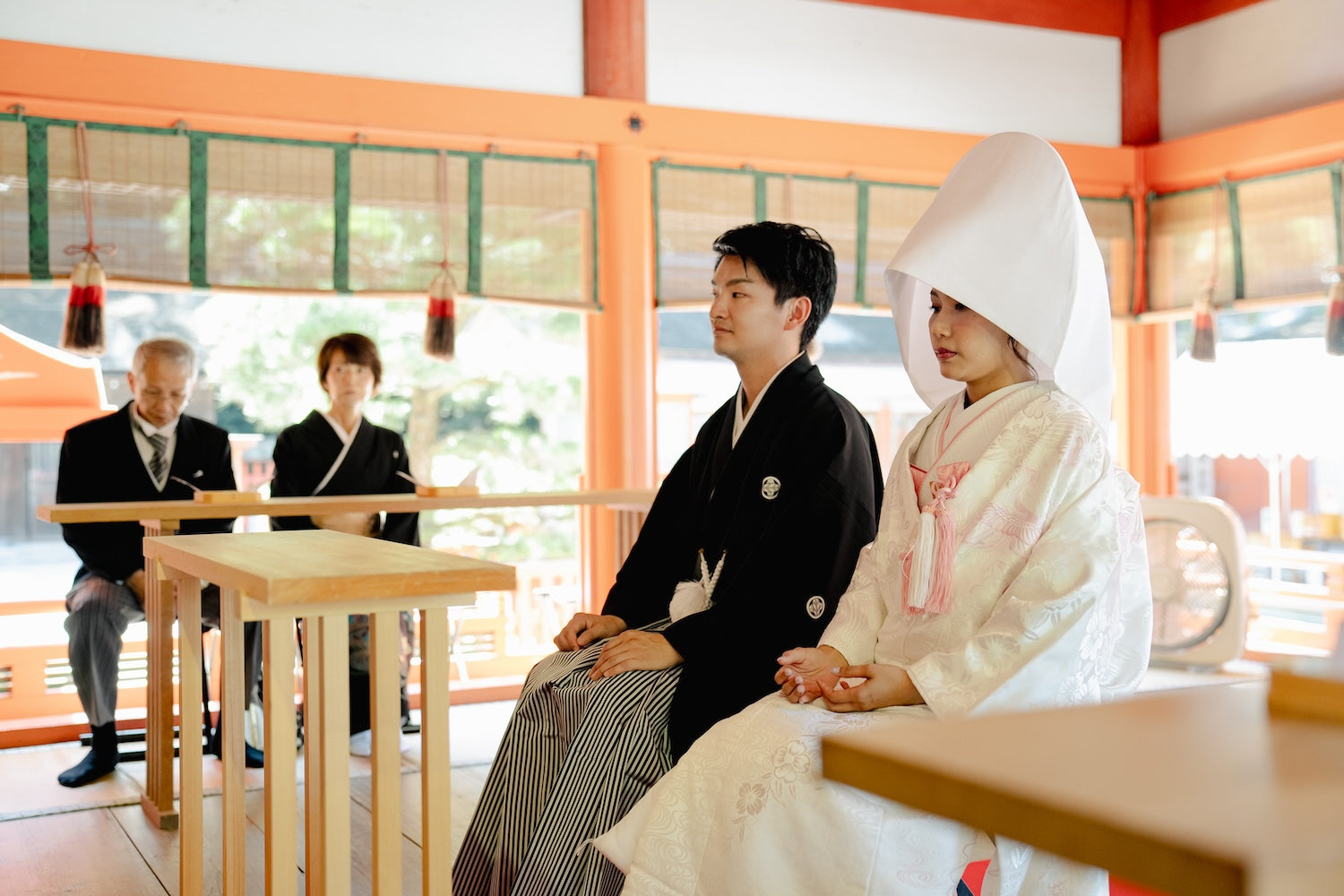 Bride and groom seated during a Shinto wedding ceremony at Kashiigu Shrine