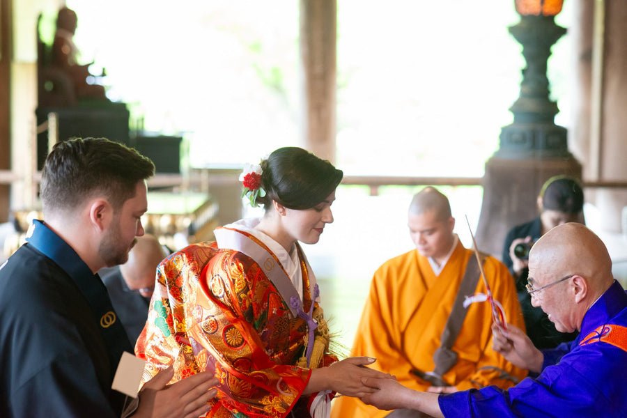 A monk presenting the kesa and juzu prayer beads to the couple at Hasedera Temple
