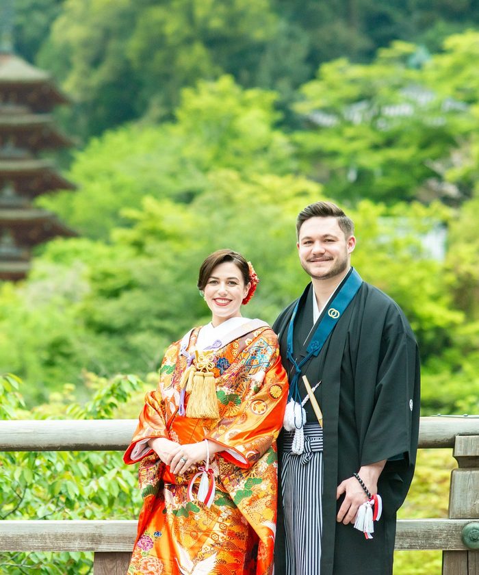 A couple in kimono before the five-storied pagoda and fresh green maples of Hasedera Temple, Nara